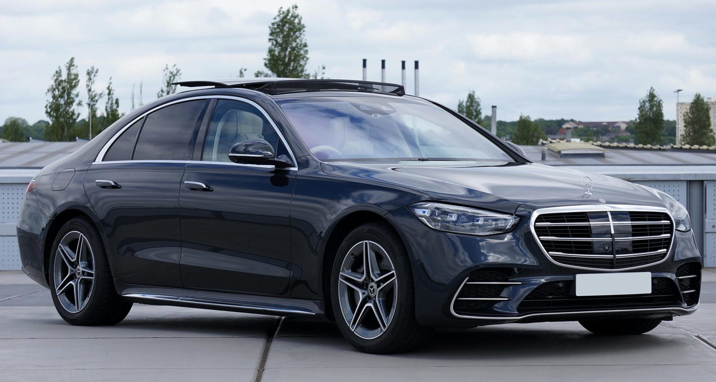 Sleek black Mercedes S-Class parked on a rooftop, showcasing luxury and elegance.